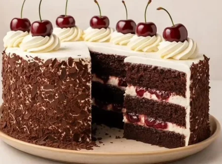 Delicious Black Forest Cake topped with cherries and whipped cream