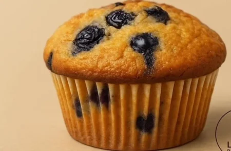 Freshly baked blueberry muffins with a golden crust and juicy blueberries