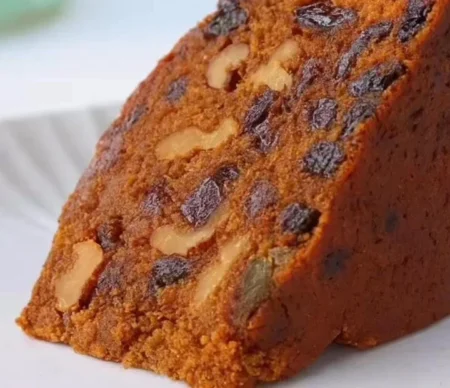 Delicious fruit cake supreme topped with colorful fruits and nuts