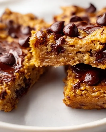 Peanut butter banana bars stacked on a rustic wooden table
